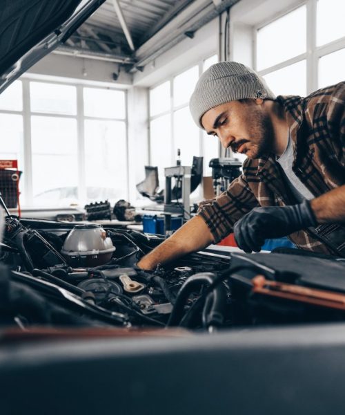 mechanic-examining-car-in-auto-car-repair-service-center